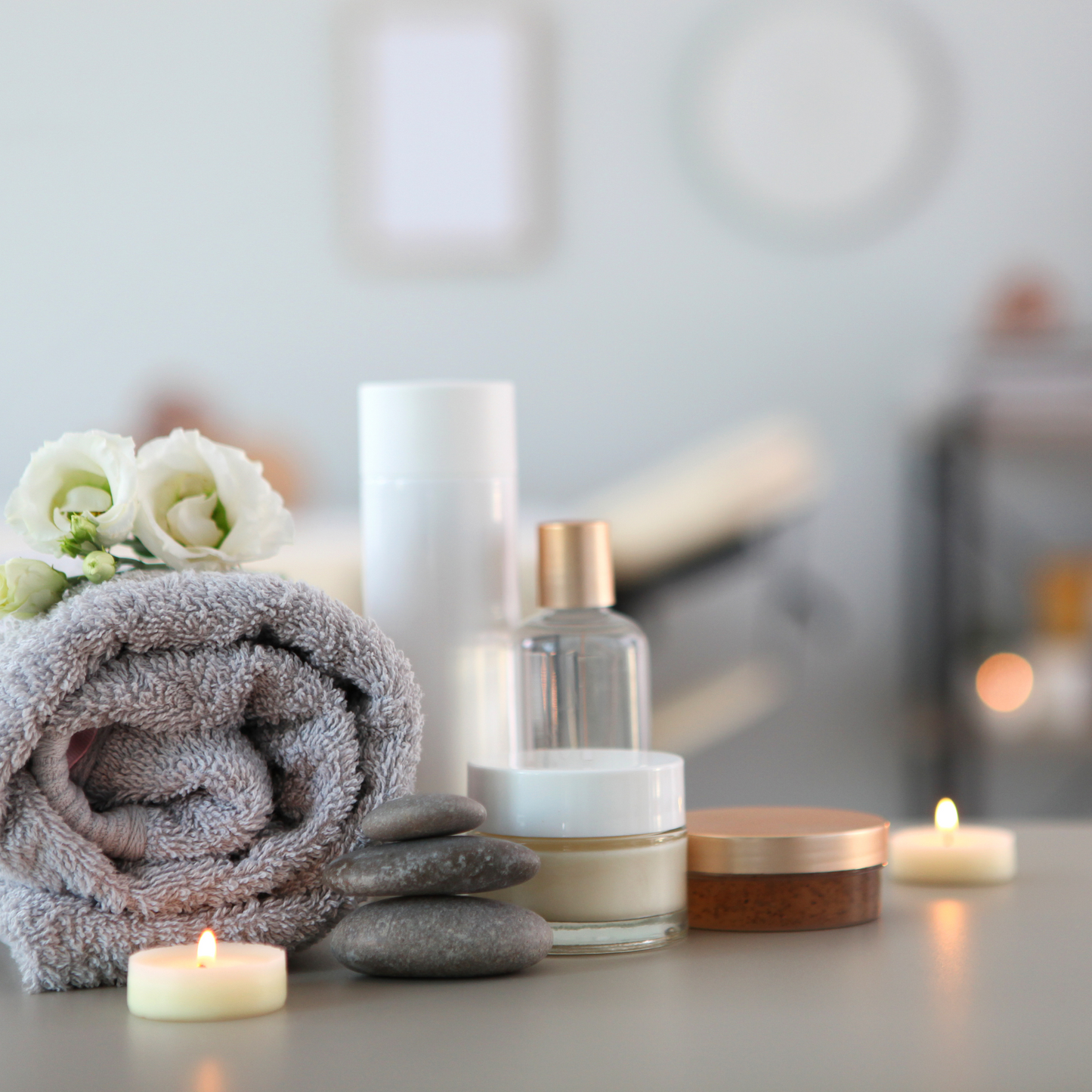 Spa ambiance with candles, towels, and skincare products at Modern Radiance Oregon spa.