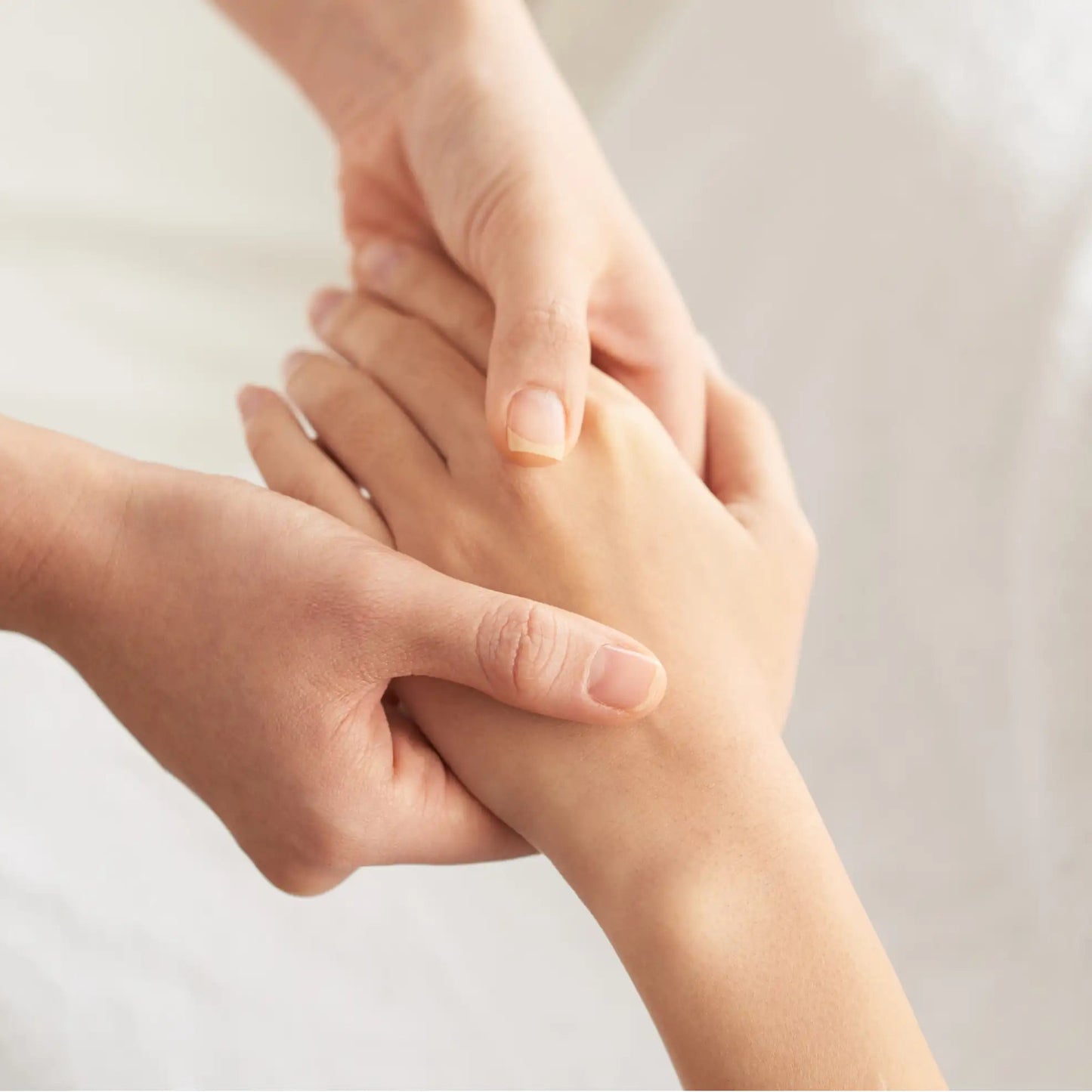 Hands receiving a professional moisturizing treatment