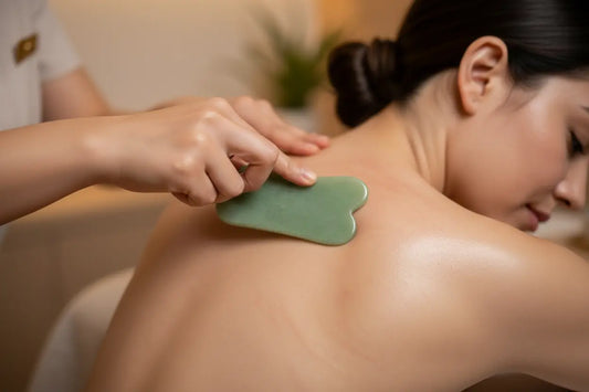 Close-up of Gua Sha therapy applied to the shoulder and upper back to support soft tissue mobility, circulation, inflammation reduction, and recovery from muscle tension. 